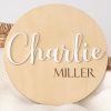 Wood and acrylic birth announcement disc with the name Charlie showing in white.