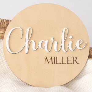 Wood & acrylic birth announcement disc with the name Charlie showing in white.