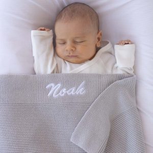 Personalised Light-Grey Baby Blanket Knitted embroidered with boys name Noah.