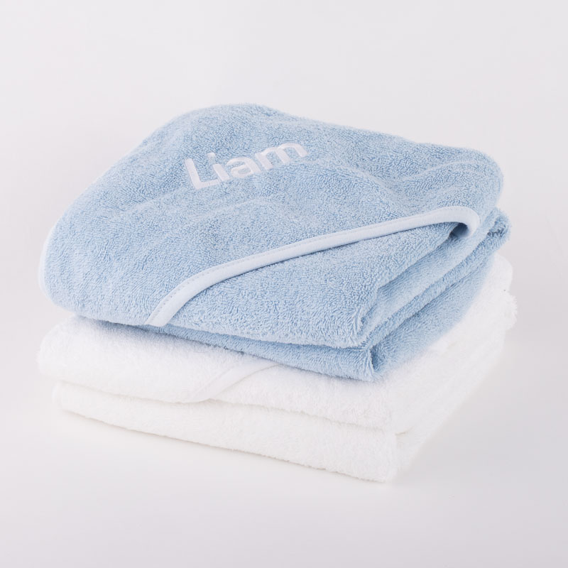 Personalised blue baby hooded towel and personalised white hooded baby towel.