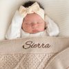 Personalised beige diamond knitted baby blanket embroidered with girls name Sierra.