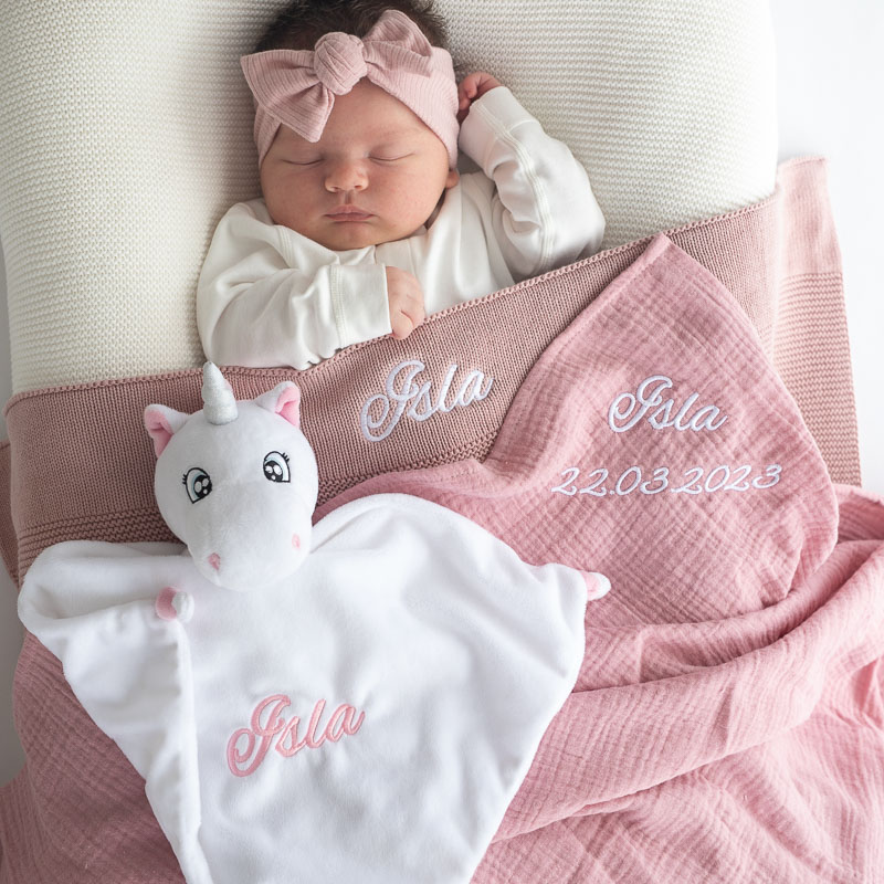 Personalised blush pink knitted blanket, unicorn comforter and pink muslin wrap baby gift ideas for girls.