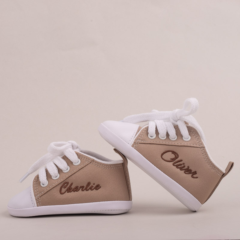 Sand coloured baby shoes personalised with baby name embroidery.