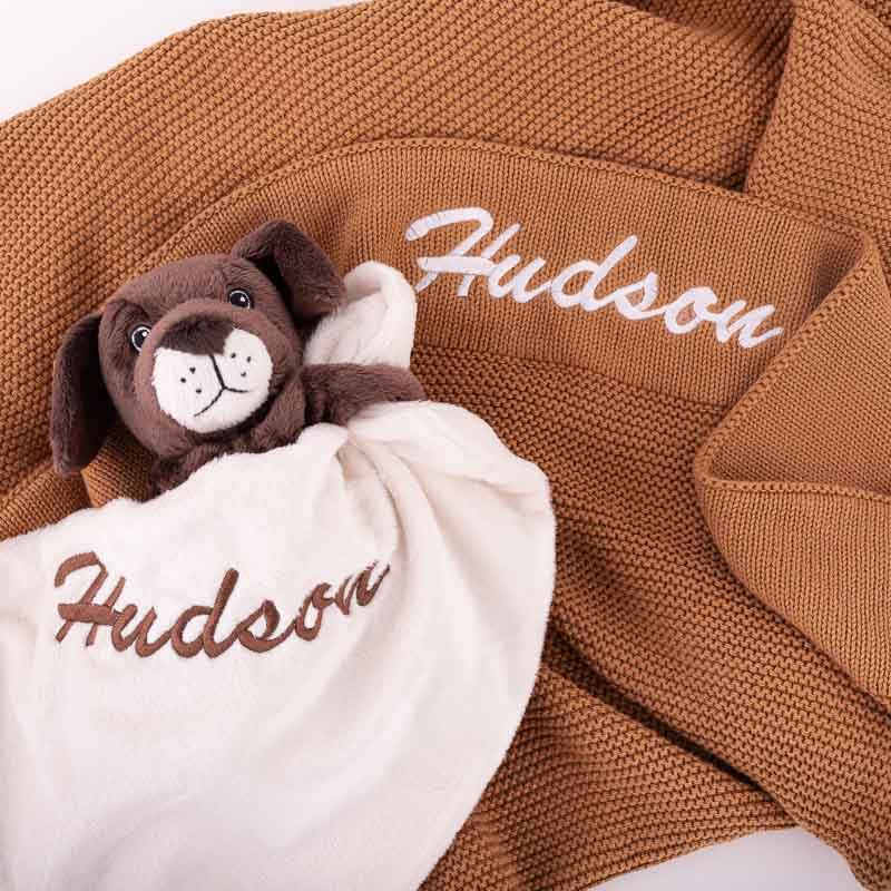 Personalised baby puppy comforter and knitted baby blanket embroidered with Hudson.