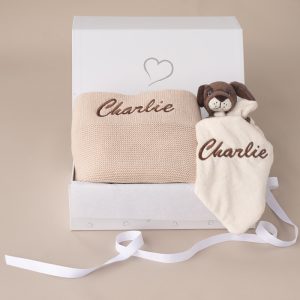 Personalised beige knitted blanket and puppy comforter inside gift box with ribbon.