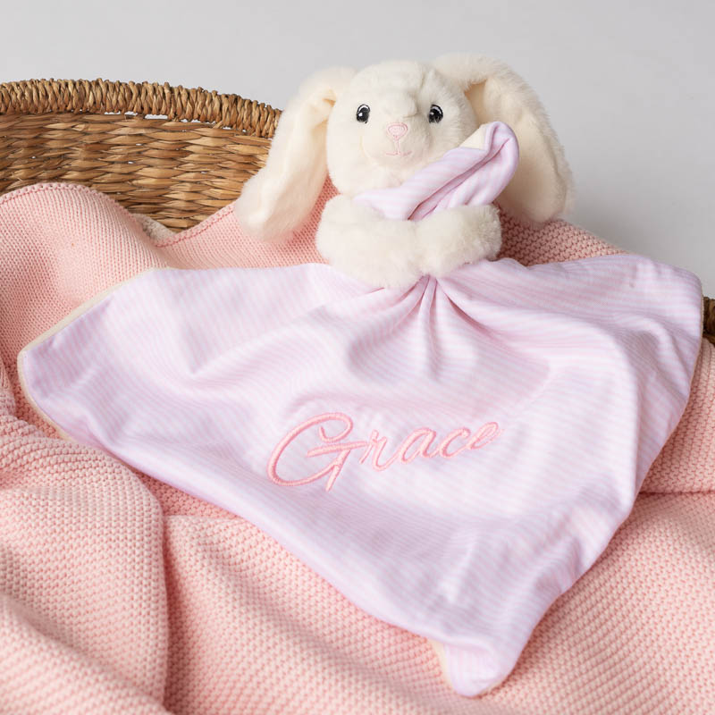 Personalised white bunny baby comforter on pink knitted blanket gift for girls.