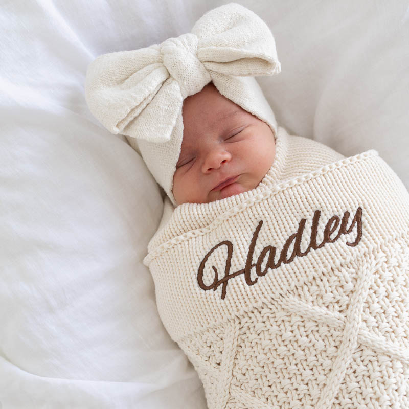 Baby Hadley wrapped in personalised cream diamond knitted blanket newborn gift.