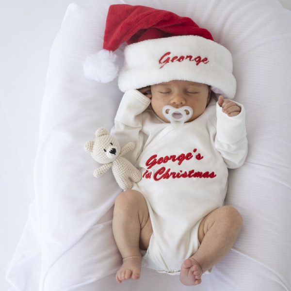 A Personalised Christmas Hat and Romper with red embroidery and a Bear Baby Rattle Gift Set.