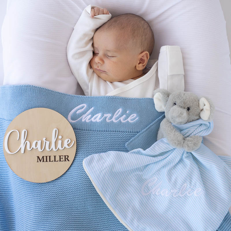 Personalised blue knitted blanket, elephant comforter and name disc baby boy gift ideas.