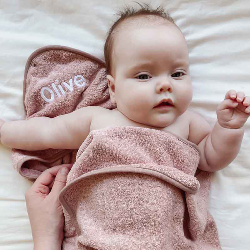 Baby Olive wrapped up in Personalised blush pink baby towel.