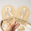 A group of birth announcement discs featuring a capitalised letter with a flower in acrylic.