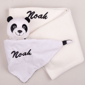 A panda baby comforter and white knitted blanket embroidered with the name Noah.