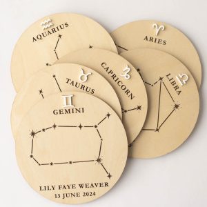 A group of birth announcement discs featuring different star signs.