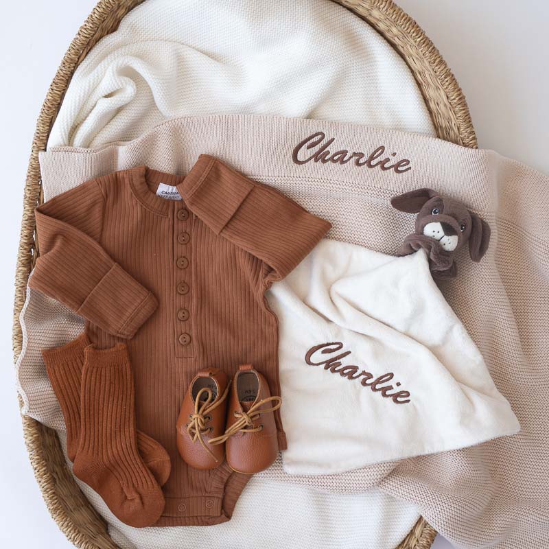 Beige Knitted Blanket, Romper, Puppy, Shoes and Socks Baby Gift ideas.