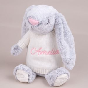 A bunny wearing a jumper embroidered with the name Amelia.