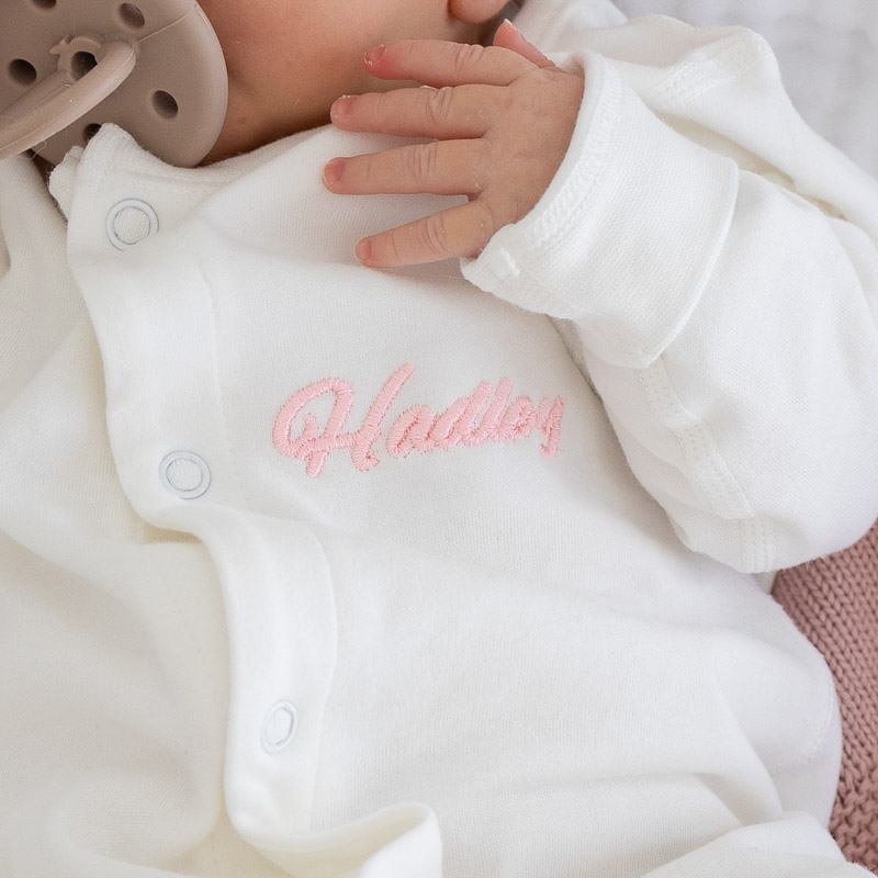 Personalised baby gift white onesie with name embroidery.